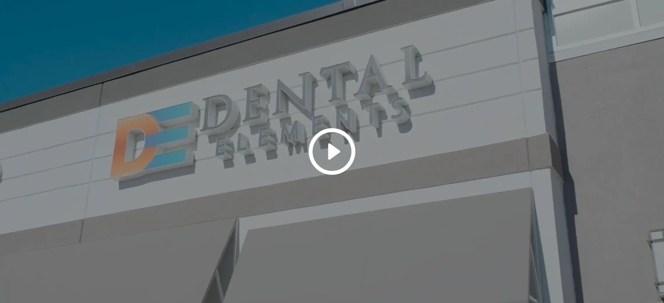 Dental Elements sign on the office wall in Shawnee, Leawood and Wellsville, KS