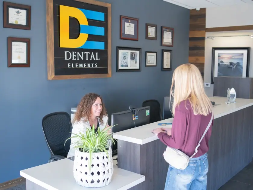 Patient checking in at the reception desk at Dental Elements in Shawnee, Leawood and Wellsville, KS